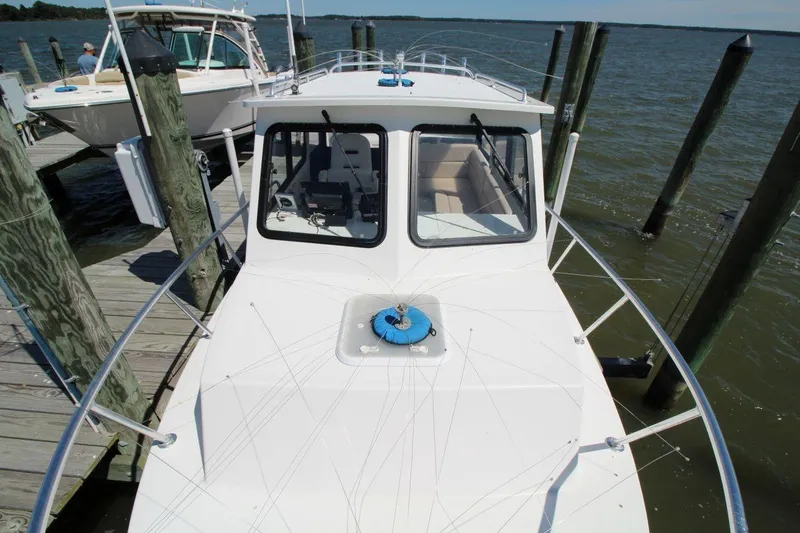 Slide: The Image of 2019 Judge 27 Chesapeake boat docked by the water. - 12