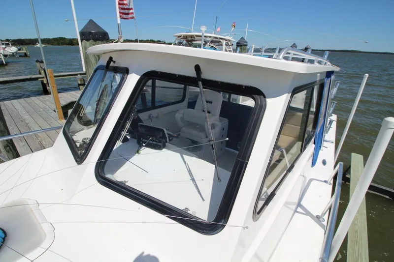 Slide: The Image of 2019 Judge 27 Chesapeake boat docked by the water on a sunny day. - 13