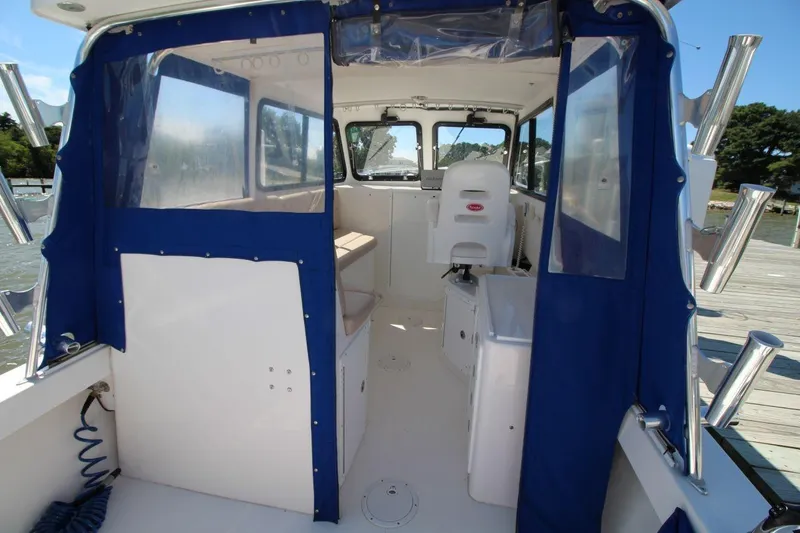 Slide: The Image of 2019 Judge 27 Chesapeake boat interior with blue canopy and seating. - 14