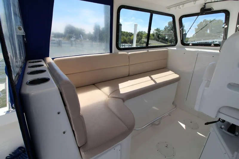 Slide: The Image of Interior of 2019 Judge 27 Chesapeake boat with beige seating and windows. - 15