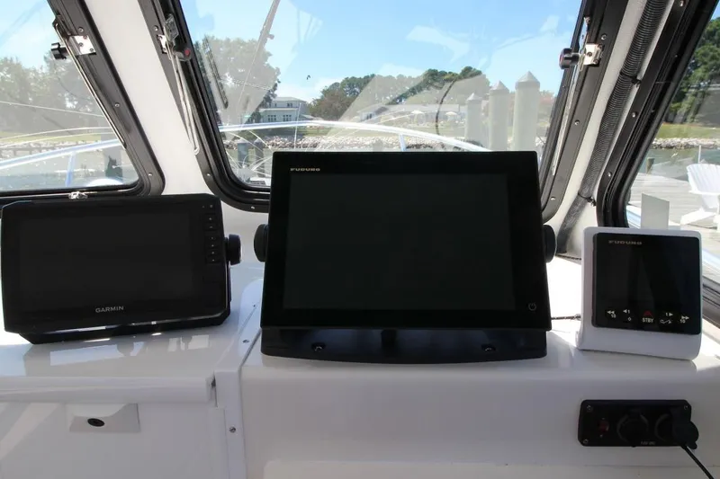 Slide: The Image of Helm of 2019 Judge 27 Chesapeake boat with Garmin and Furuno navigation displays. - 18