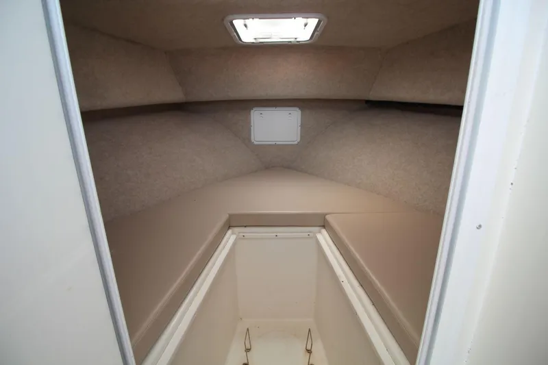 Slide: The Image of 2019 Judge 27 Chesapeake boat cabin interior with beige cushions and overhead hatch. - 21