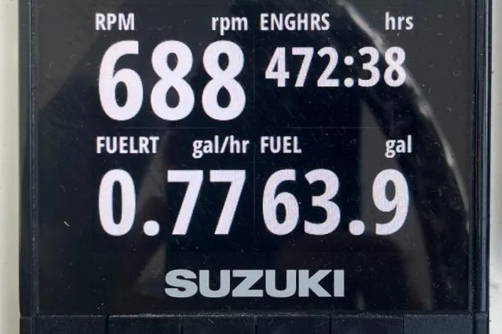 Slide: The Image of Digital display showing engine RPM, hours, and fuel usage for a Suzuki engine. - 24