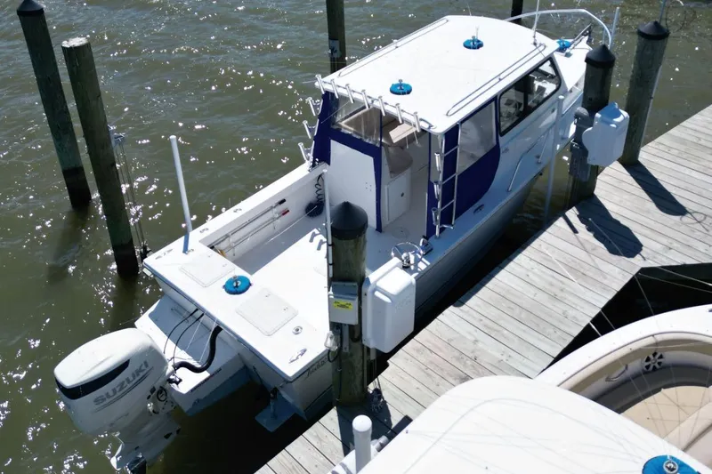 Slide: The Image of 2019 Judge 27 Chesapeake boat docked with Suzuki outboard motor. - 3