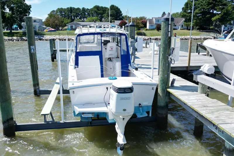 Slide: The Image of 2019 Judge 27 Chesapeake boat docked at marina with outboard motor. - 5