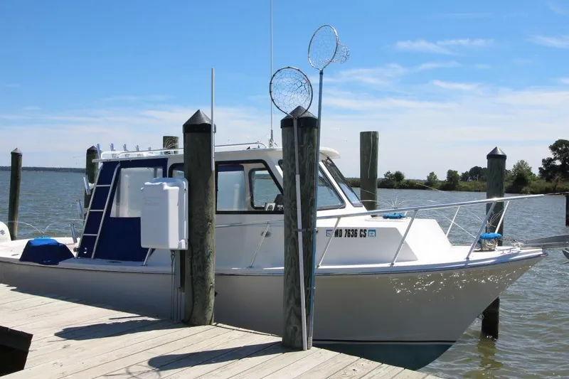 Slide: The Image of 2019 Judge 27 Chesapeake boat docked by the water on a sunny day. - 6