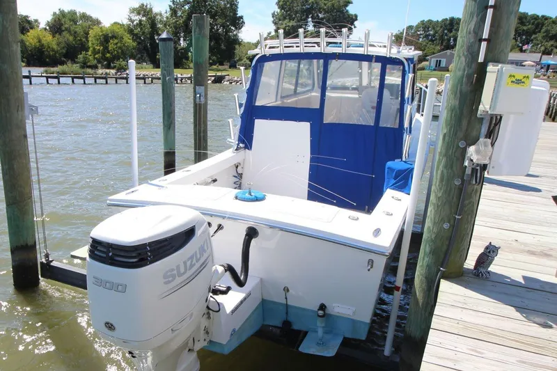 Slide: The Image of 2019 Judge 27 Chesapeake boat docked with Suzuki 300 outboard motor. - 7