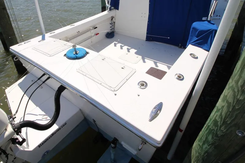 Slide: The Image of 2019 Judge 27 Chesapeake boat deck with fishing rod holders and storage compartments. - 8