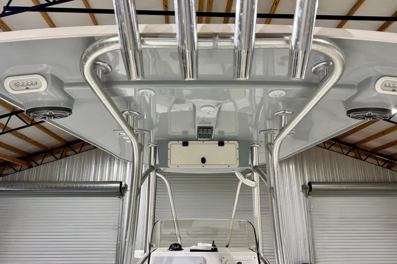 Slide: The Image of 2023 BlackJack 256 Coastal boat interior with stainless steel rod holders and speakers. - 14