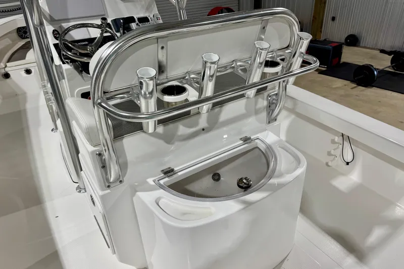 Slide: The Image of 2023 BlackJack 256 Coastal boat interior with rod holders and steering console. - 7
