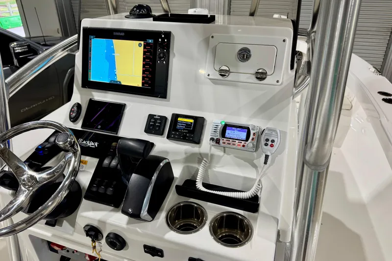 Slide: The Image of 2023 BlackJack 256 Coastal boat dashboard with navigation and control systems. - 9