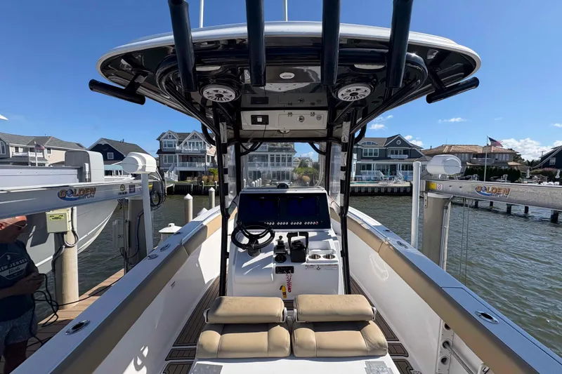 Slide: The Image of 2018 Sportsman Open 252 Center Console boat docked near waterfront homes. - 5