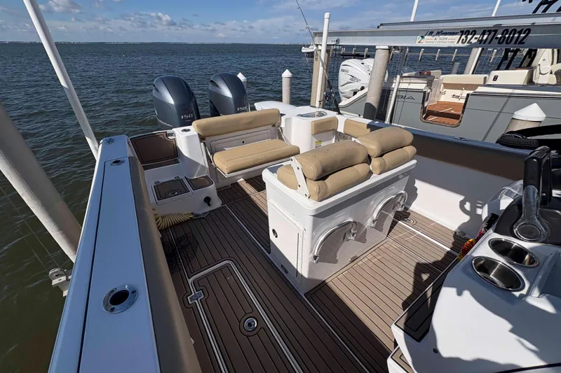 Slide: The Image of 2018 Sportsman Open 252 Center Console boat with dual engines and cushioned seating. - 8