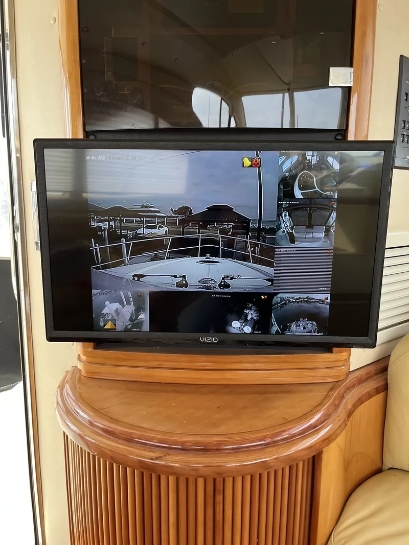 Slide: The Image of A screen on a 2003 Azimut 46 MY displays surveillance cameras with various views of the boat. - 15