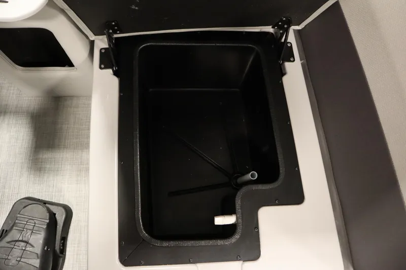 Slide: The Image of Open storage compartment in a 2026 Lowe LF 194 boat interior. - 16