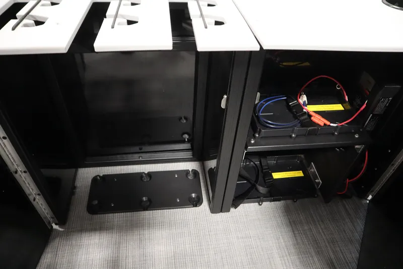 Slide: The Image of Open compartments with wiring in a 2026 Lowe LF 194 boat interior. - 18
