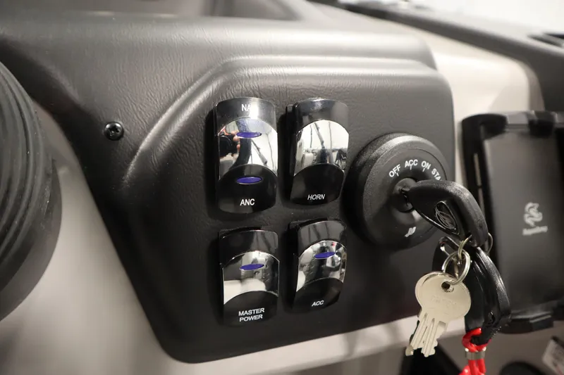 Slide: The Image of Control panel of 2026 Lowe LF 194 boat with switches and ignition keys. - 26