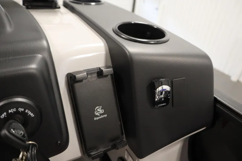 Slide: The Image of Control panel of 2026 Lowe LF 194 boat with cup holder and AquaAmp feature. - 27