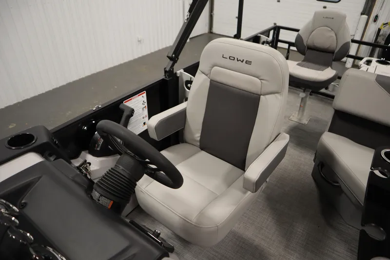 Slide: The Image of 2026 Lowe LF 194 boat interior with comfortable seating and steering wheel. - 29