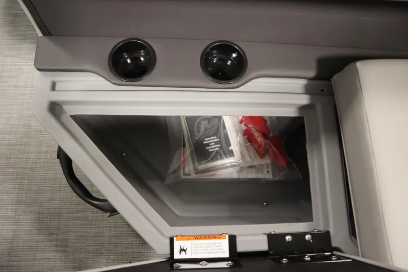 Slide: The Image of Interior storage compartment of 2026 Lowe LF 194 boat with cup holders and manuals. - 33
