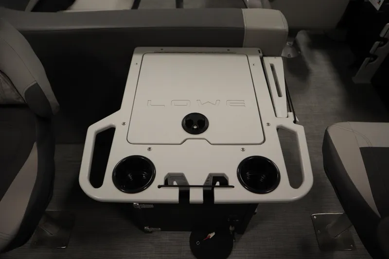 Slide: The Image of 2026 Lowe LF 194 boat interior with storage compartment and cup holders. - 38