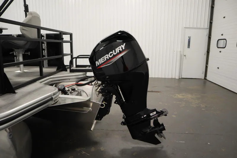 Slide: The Image of 2026 Lowe LF 194 boat with Mercury outboard motor in a garage setting. - 43