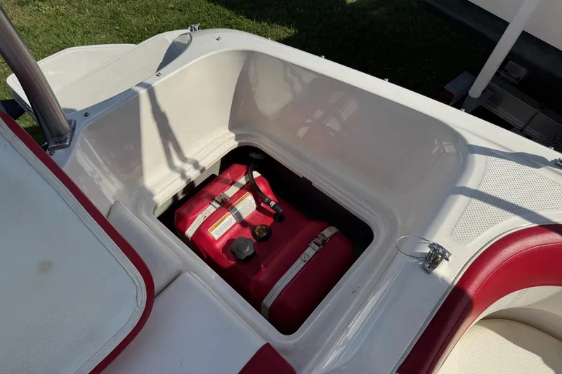 Slide: The Image of 2013 Bayliner Element boat storage compartment with red fuel tank. - 10