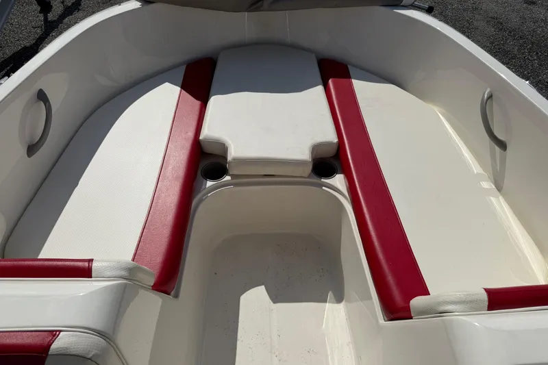 Slide: The Image of 2013 Bayliner Element boat interior with red and white seating. - 14