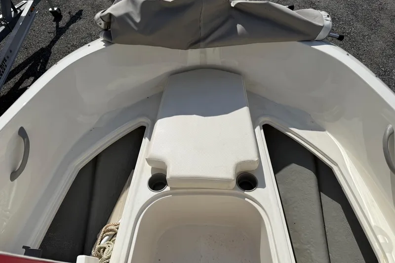 Slide: The Image of 2013 Bayliner Element boat interior with seating and storage compartments. - 15