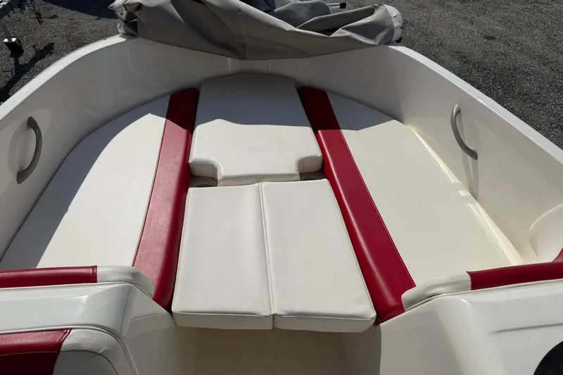 Slide: The Image of 2013 Bayliner Element boat interior with red and white seating. - 17