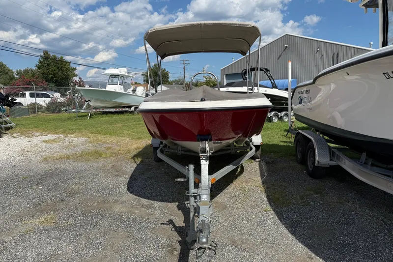 Slide: The Image of 2013 Bayliner Element boat on trailer, parked outdoors under a clear sky. - 3
