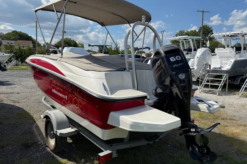 Slide: The Image of 2013 Bayliner Element boat with Mercury 60 engine, parked on a trailer. - 7