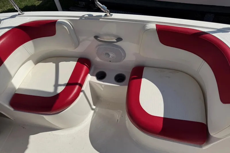 Slide: The Image of 2013 Bayliner Element boat seating with red and white upholstery, featuring cup holders. - 8