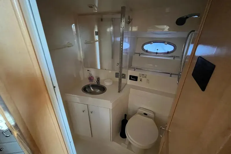 Slide: The Image of Bathroom interior of 1998 Carver 355 Aft Cabin yacht, featuring sink and toilet. - 18