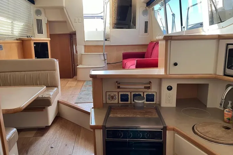 Slide: The Image of Interior of 1998 Carver 355 Aft Cabin yacht with kitchen and seating area. - 20