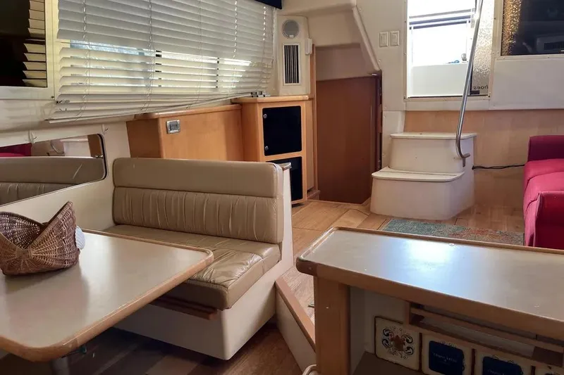 Slide: The Image of 1998 Carver 355 Aft Cabin interior with dining area, stairs, and seating. - 21