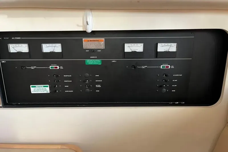 Slide: The Image of Control panel of a 1998 Carver 355 Aft Cabin boat, featuring gauges and switches. - 25