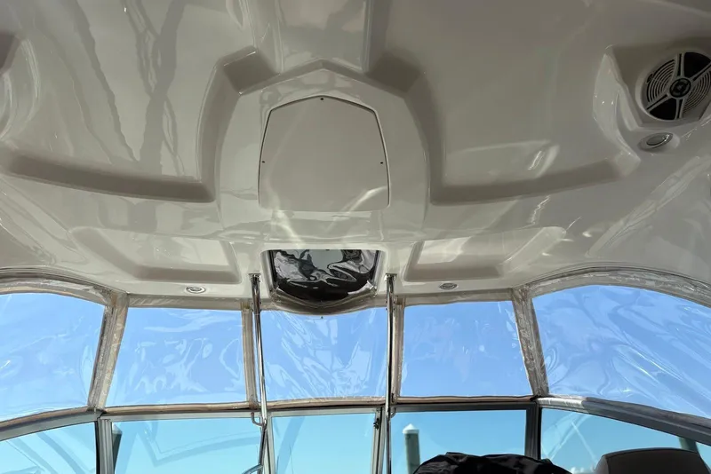 Slide: The Image of Interior view of 2011 Chaparral 330 Signature boat with clear canopy and ceiling details. - 11