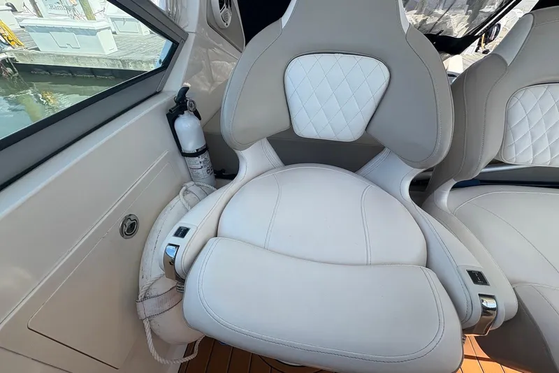 Slide: The Image of Luxury seating on 2011 Chaparral 330 Signature boat, featuring white leather upholstery. - 12