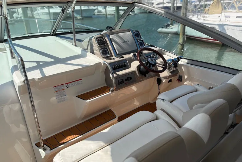 Slide: The Image of 2011 Chaparral 330 Signature boat cockpit with steering wheel and navigation system. - 13