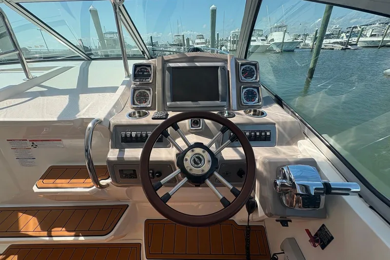 Slide: The Image of Helm of 2011 Chaparral 330 Signature boat with steering wheel and control panel. - 14
