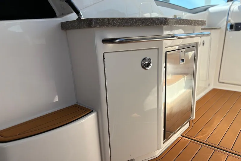 Slide: The Image of 2011 Chaparral 330 Signature boat interior with sleek cabinetry and wood flooring. - 15