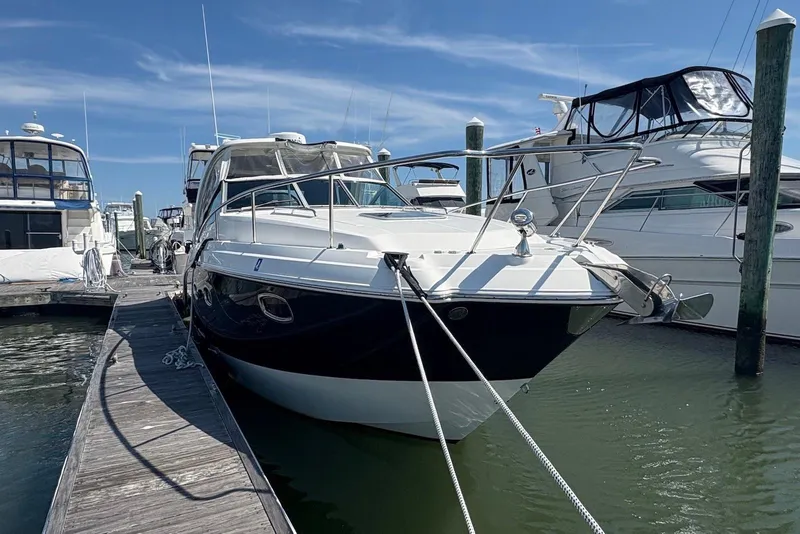Slide: The Image of 2011 Chaparral 330 Signature yacht docked at marina under clear blue sky. - 2