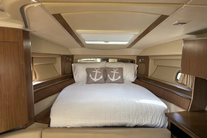 Slide: The Image of Luxurious cabin interior of 2011 Chaparral 330 Signature yacht with cozy bed and nautical decor. - 20