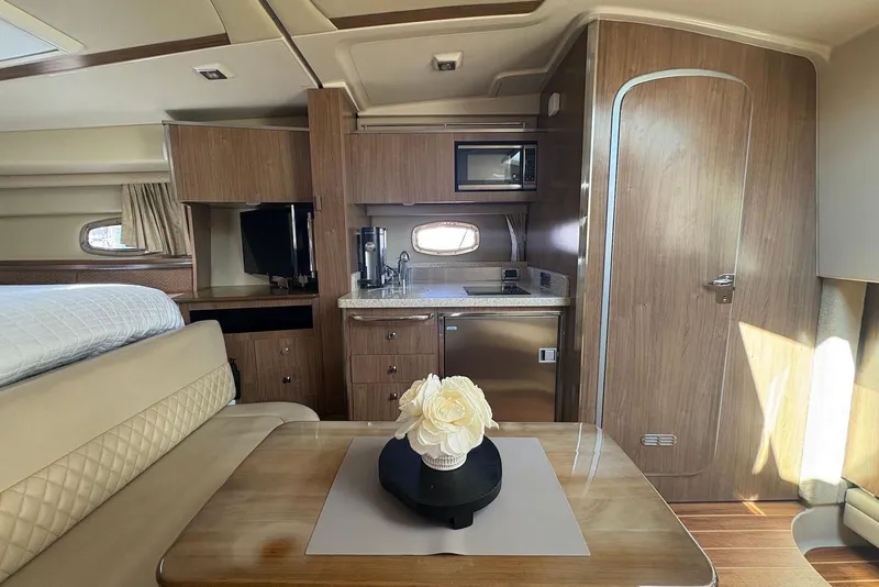 Slide: The Image of Interior of 2011 Chaparral 330 Signature yacht with kitchenette and seating area. - 21