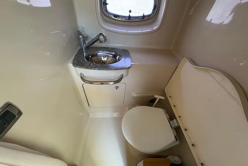 Slide: The Image of 2011 Chaparral 330 Signature boat bathroom with sink and toilet. - 23