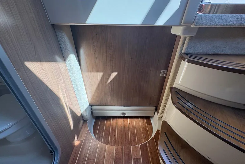 Slide: The Image of Interior of 2011 Chaparral 330 Signature boat with wooden flooring and stairs. - 26