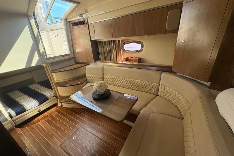 Slide: The Image of Luxurious interior of 2011 Chaparral 330 Signature yacht with elegant seating and wood finishes. - 29