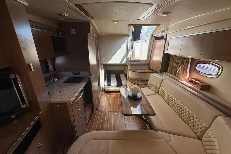 Slide: The Image of Luxurious interior of 2011 Chaparral 330 Signature yacht with elegant seating and kitchenette. - 32