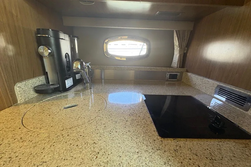 Slide: The Image of 2011 Chaparral 330 Signature yacht kitchen with coffee maker and stovetop. - 33